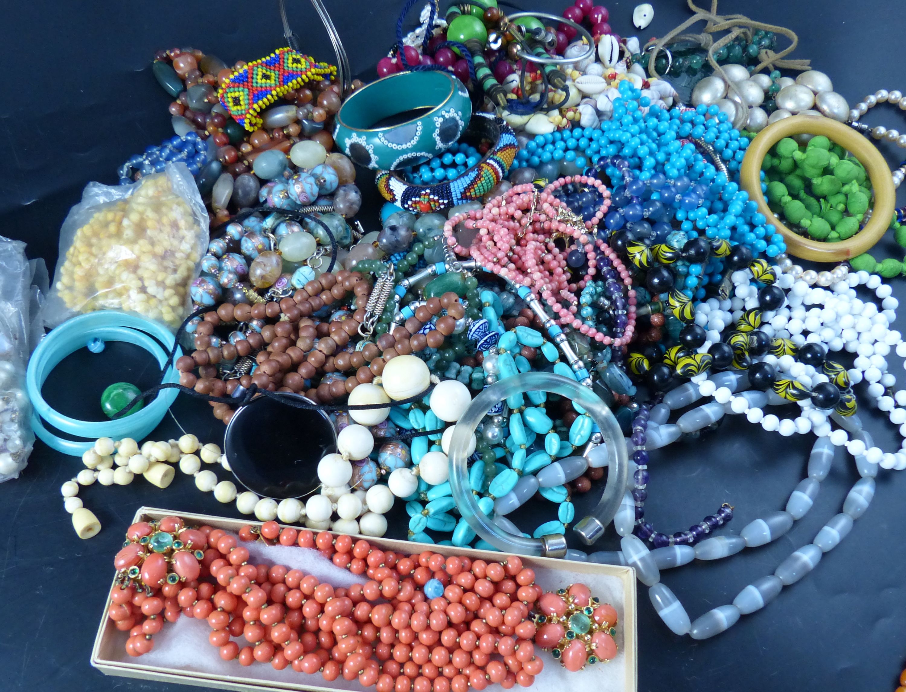 A collection of costume jewellery, principally necklaces, including an egg yolk amber bead necklace